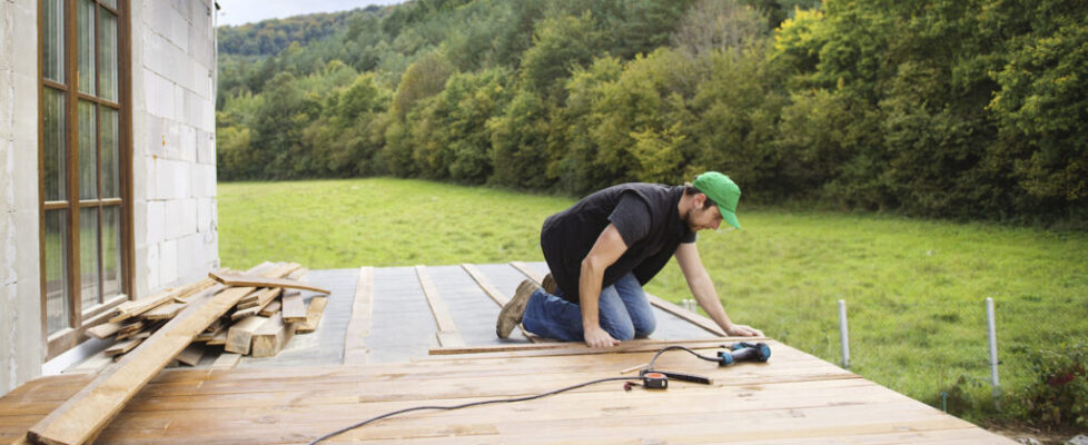 Handyman installing wooden flooring